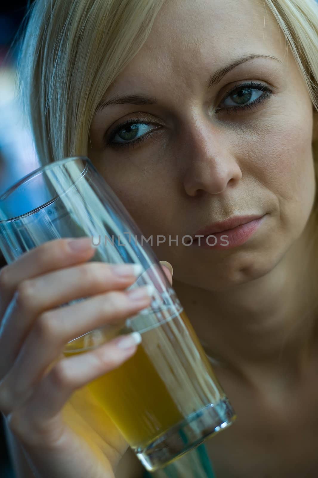 Young woman enjoying a beer at a bar