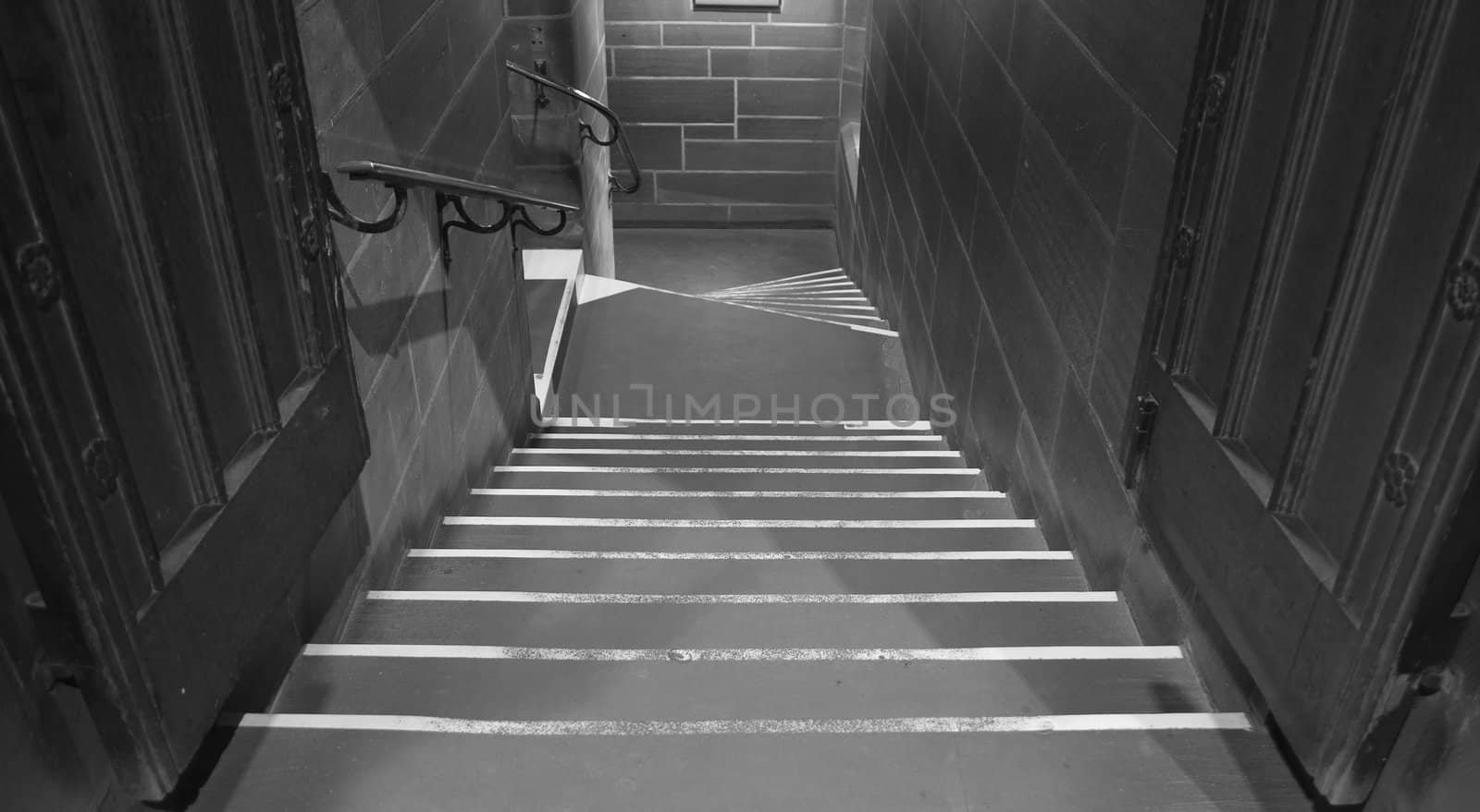 Looking down the steps in very old sandstone building