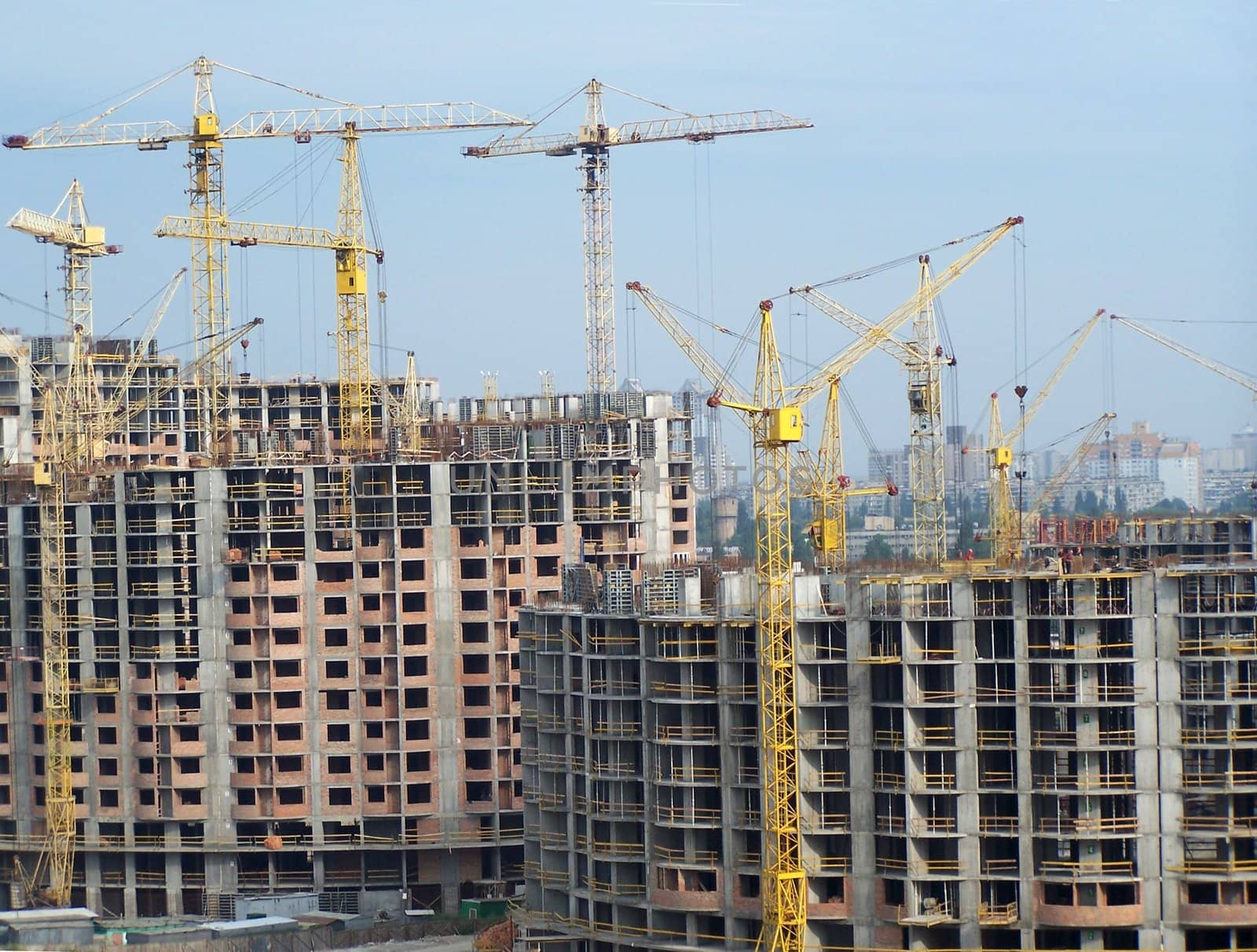 Bullding. Lifting cranes. Background. Day light. Colorful.