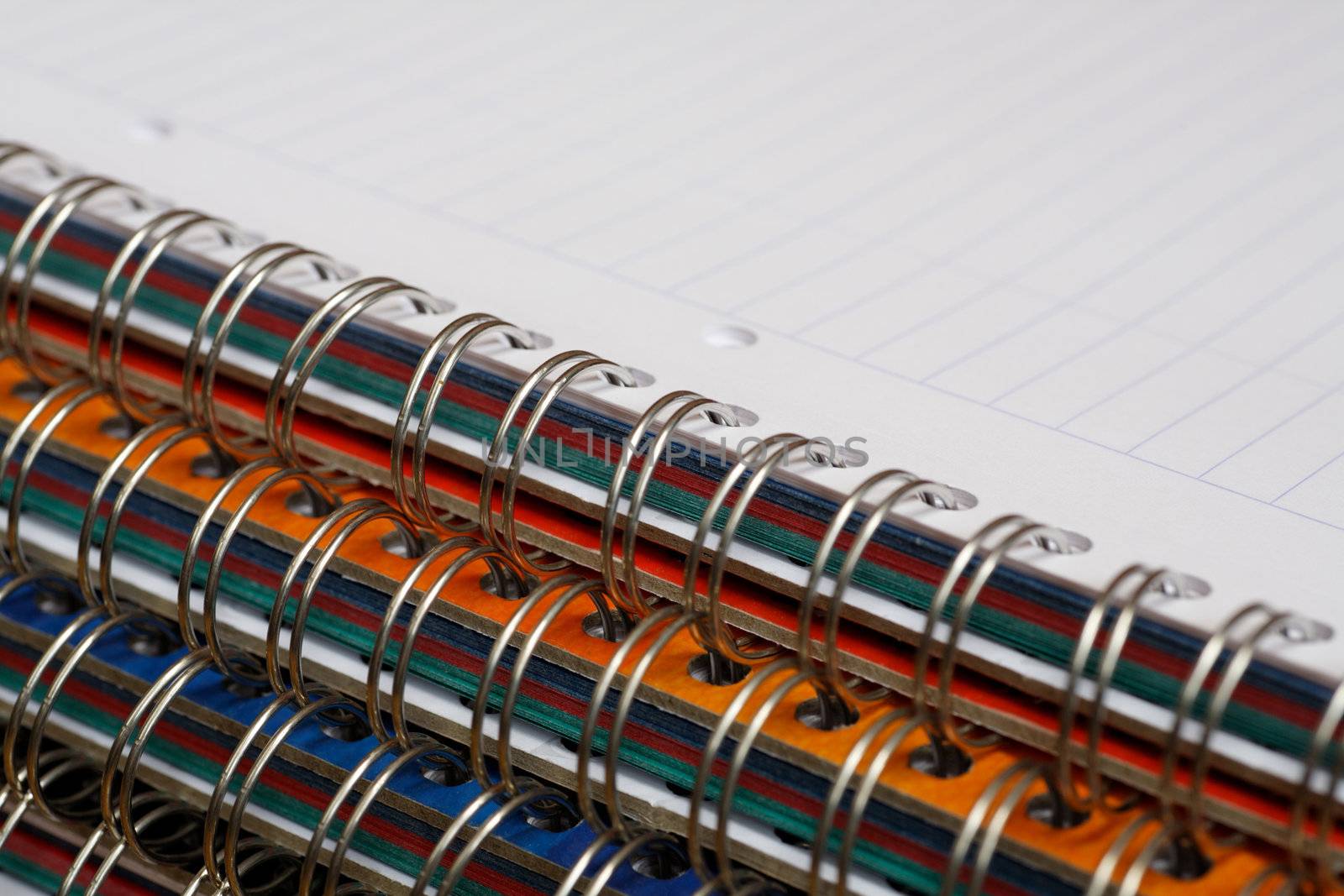 A stack of spiral-bound notebooks.