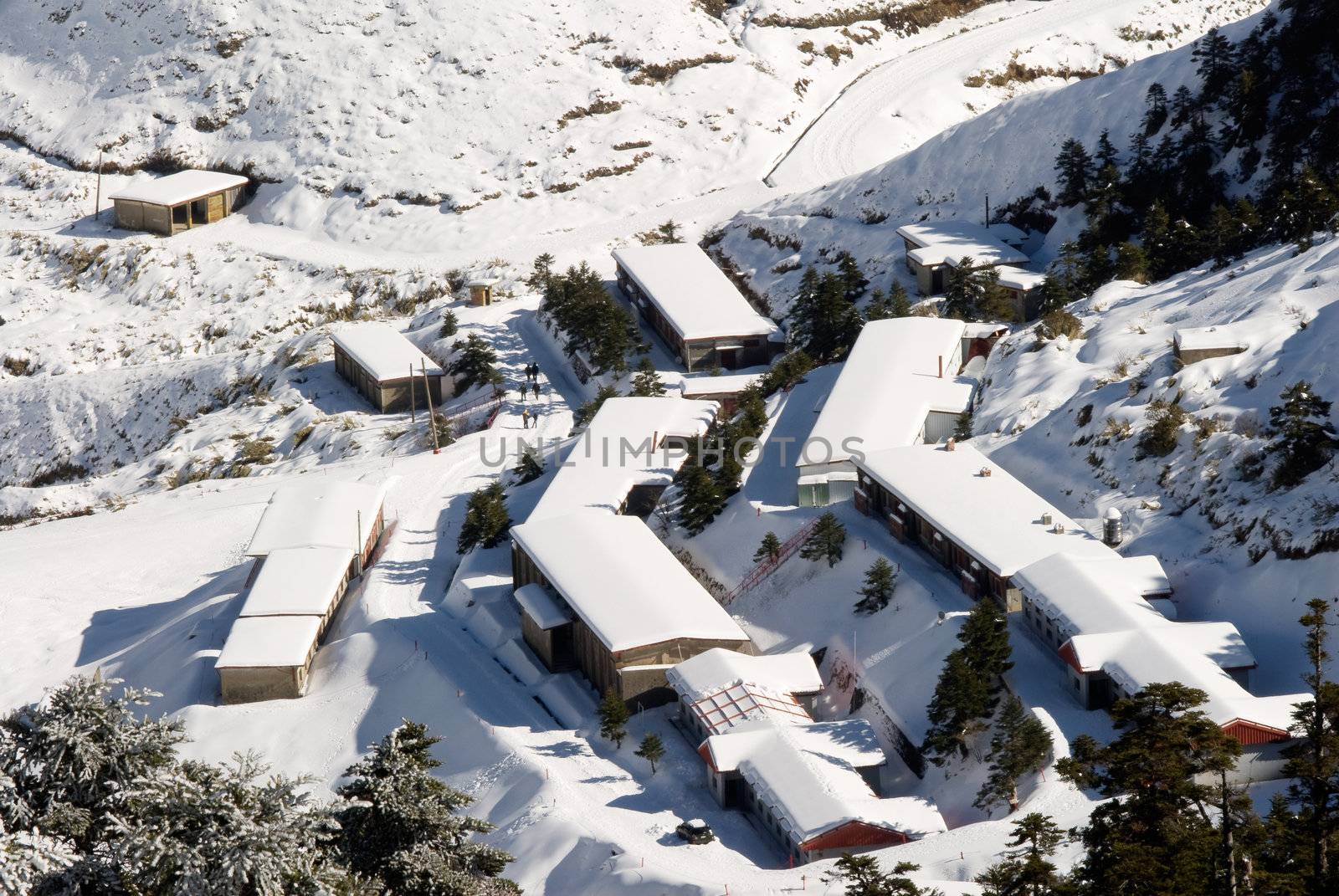 Snow town in winter with white buildings and house.
