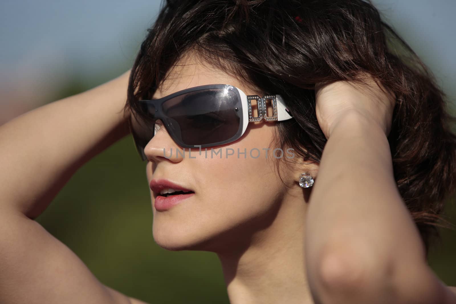 young lady with dark sun glasses outdoor