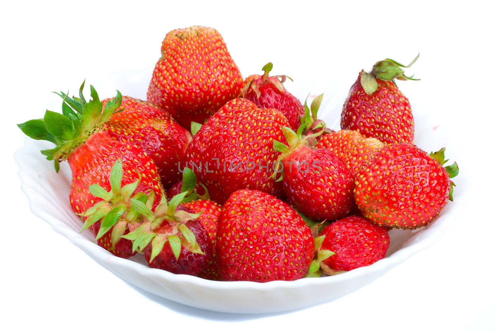 close-up of ripe strawberries on plate, isolated over white background