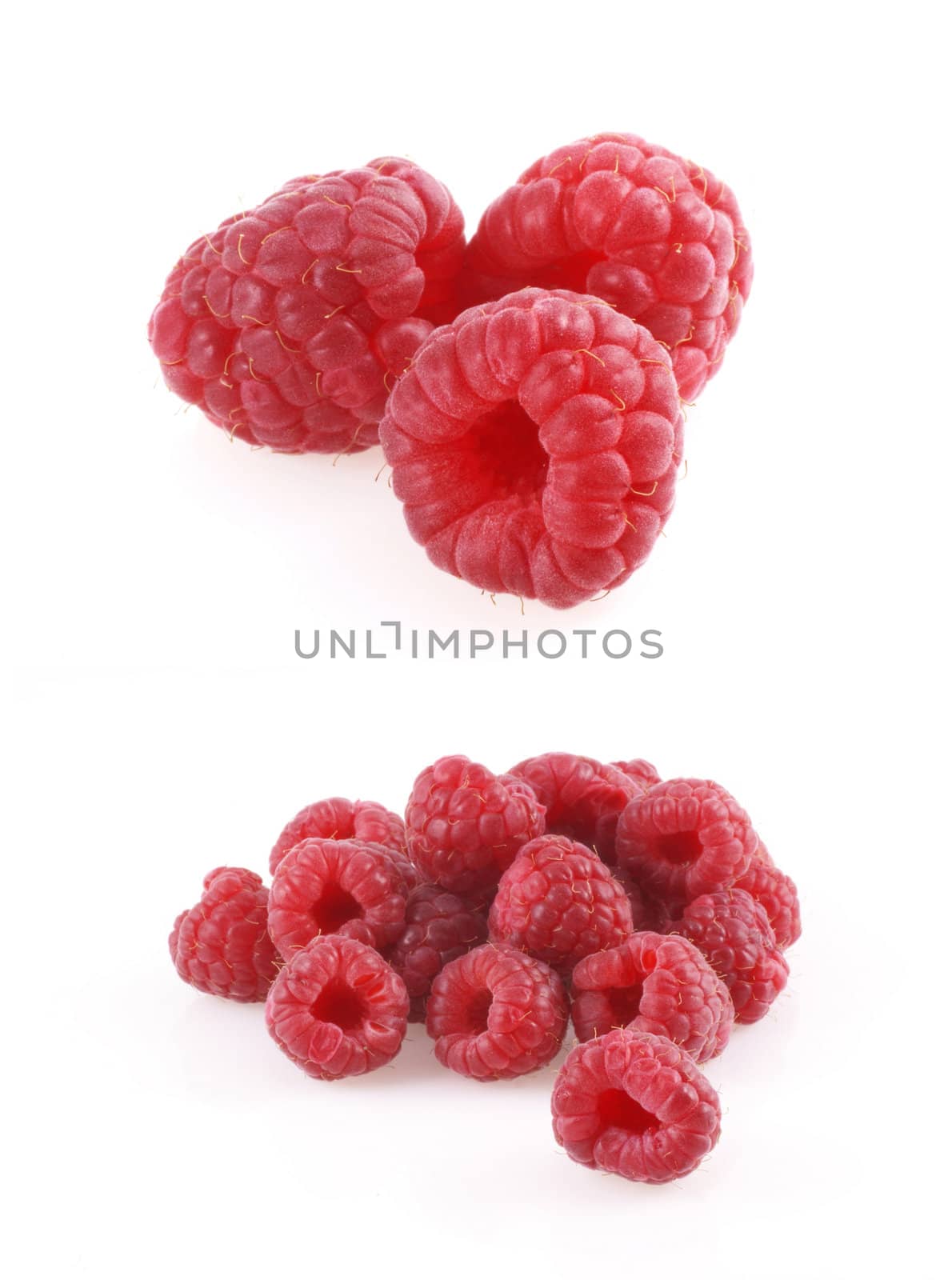 Close up of some beautiful ripe raspberries isolated on a white background.