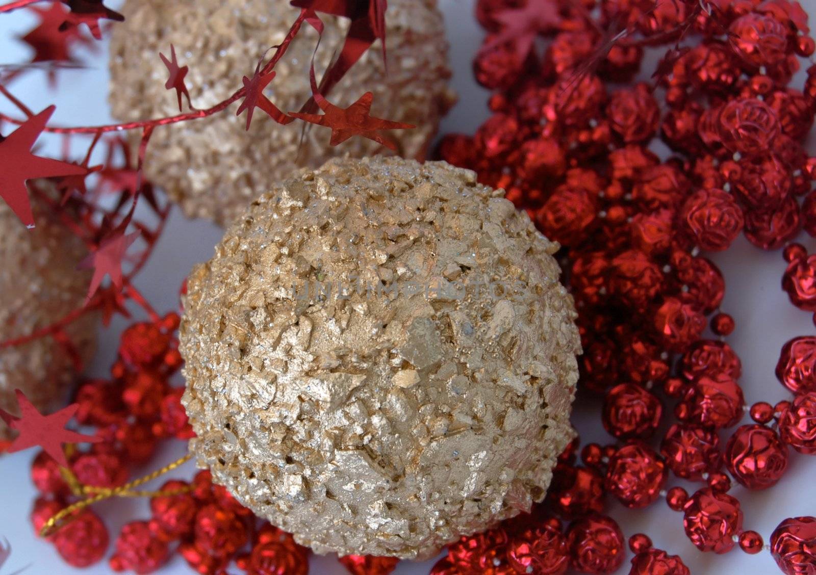 christmas decorations, shiny gold sphere and red garland