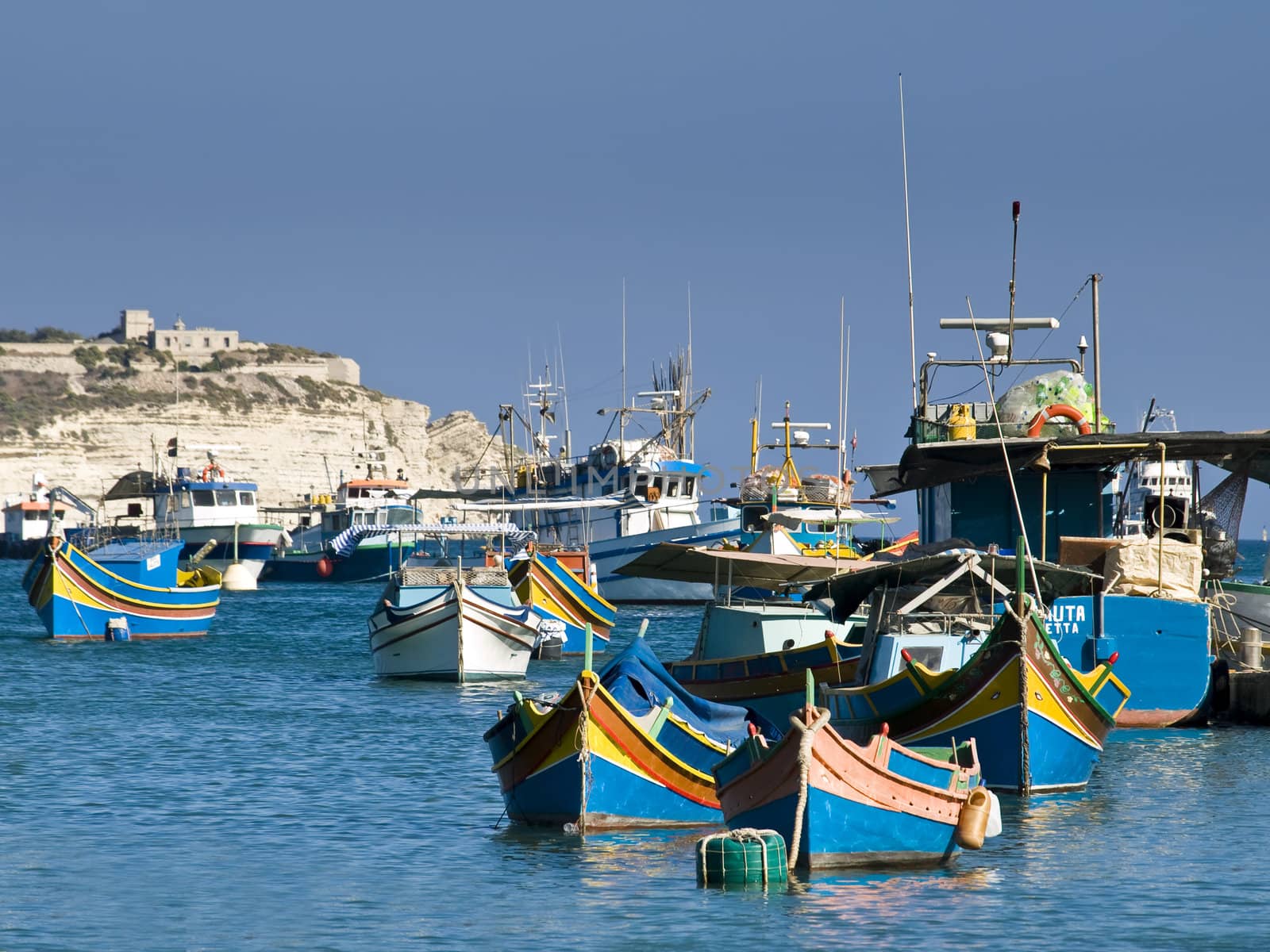 Traditional fishing boats of Malta in the fishing village of Marsaxlokk