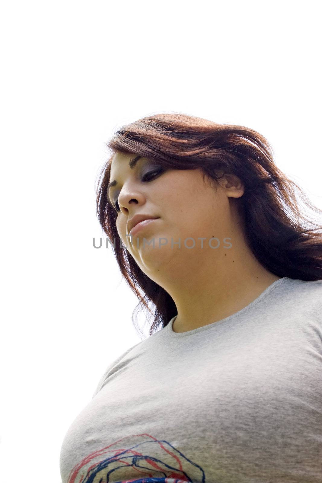 A young woman that looks a little depressed.  Plenty of copy space with the girl isolated over white.