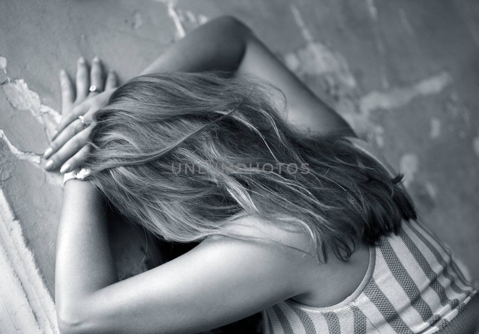 The girl with long hair at an old wall