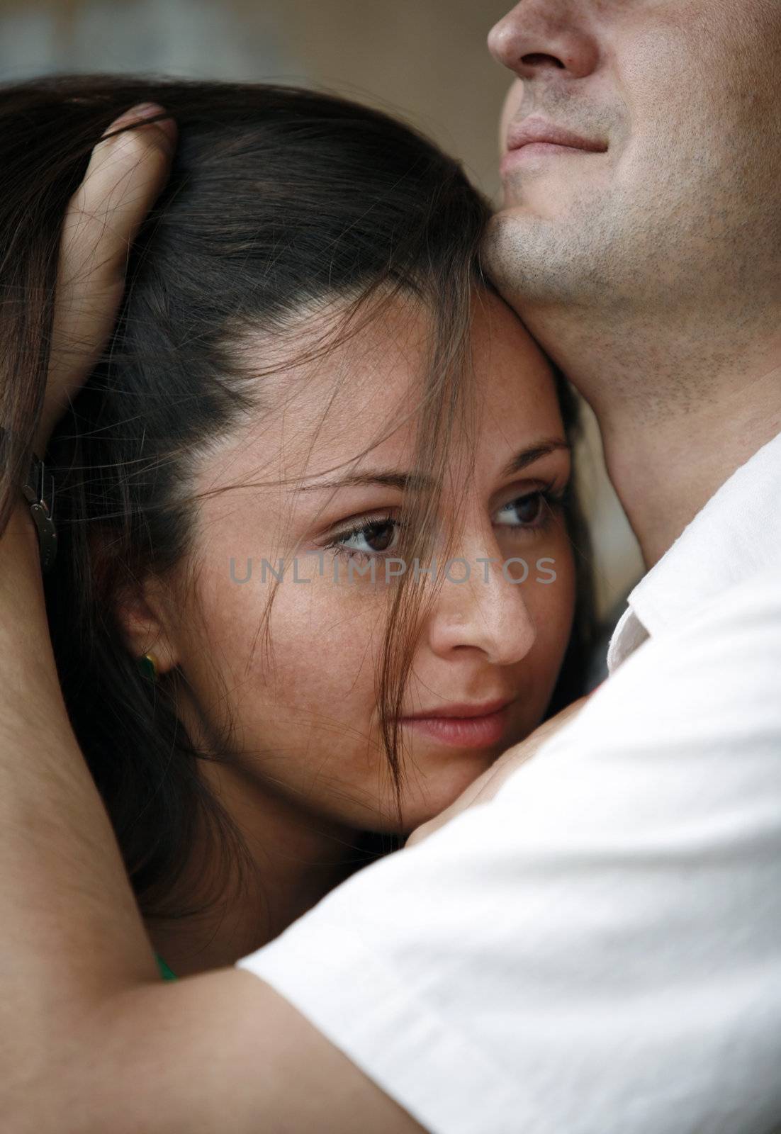 Attractive brunette in embraces of the man