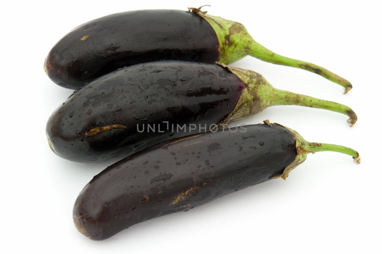 Three big eggplants on a white background.