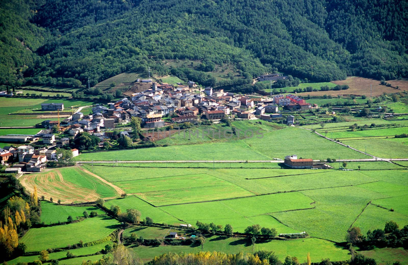 Villages and farms sit in a valley in the Pyrenees mountain range in Spain.