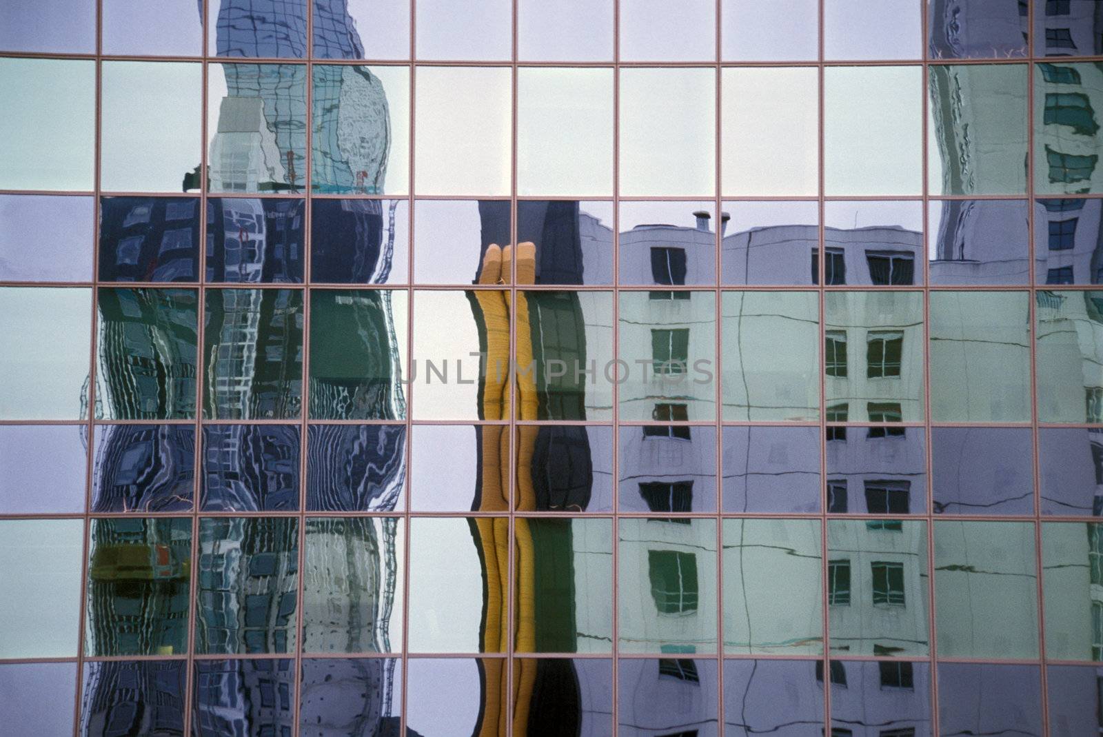 Reflection of a modern office building in the mirrored glass of another office tower. 