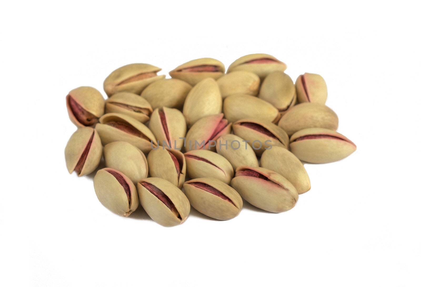 Some pistachios isolated over a white background.
