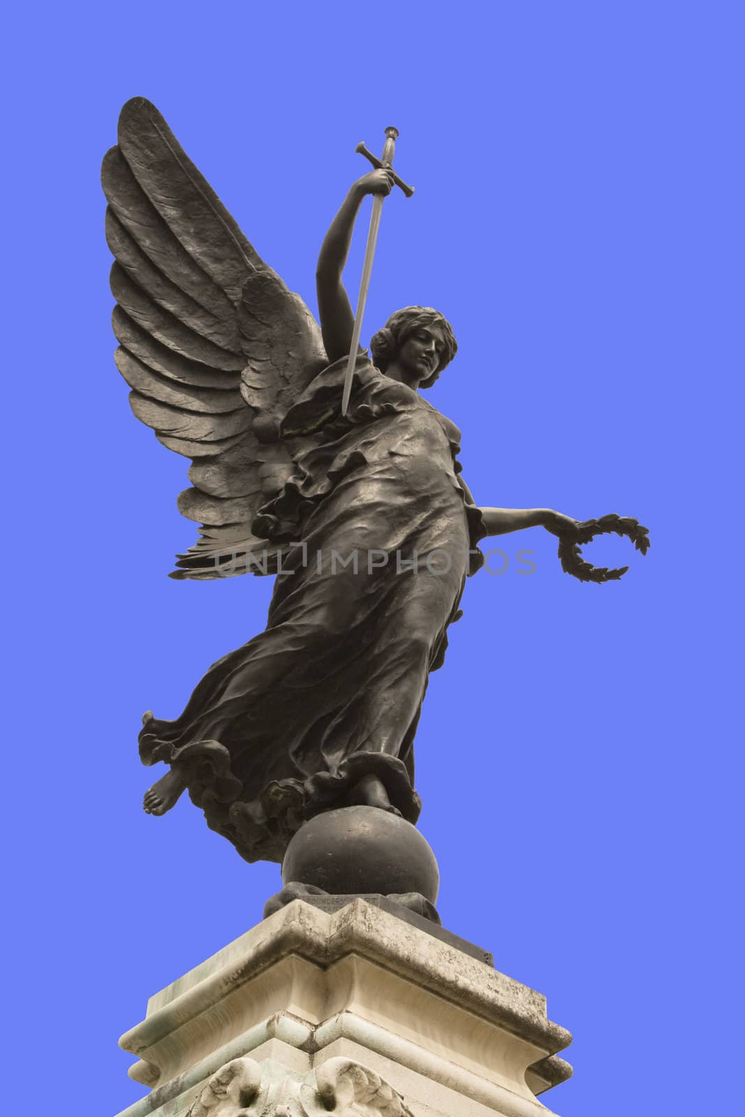 Winged statue of Victory in Colchester War Memorial. In her right hand she is holding a sword, point downwards so that it represents "The Cross of Sacrifice" and "The Sword of Devotion," and in her left a wreath of laurel. 