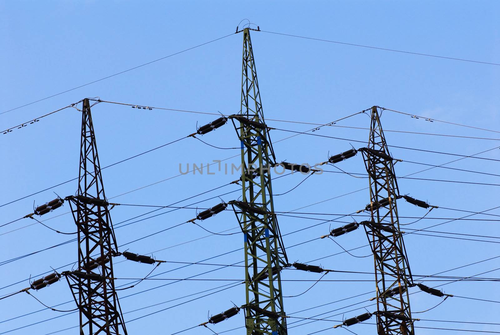 Support of an electricity transmission on a background of the clear blue sky.