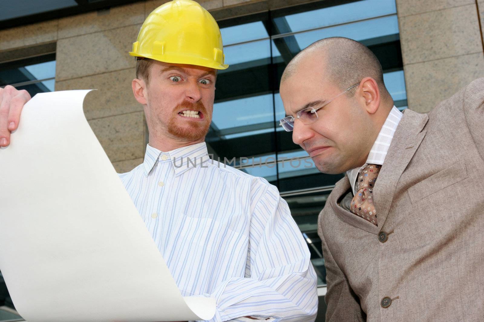 angry architect and businessman with architectural plans