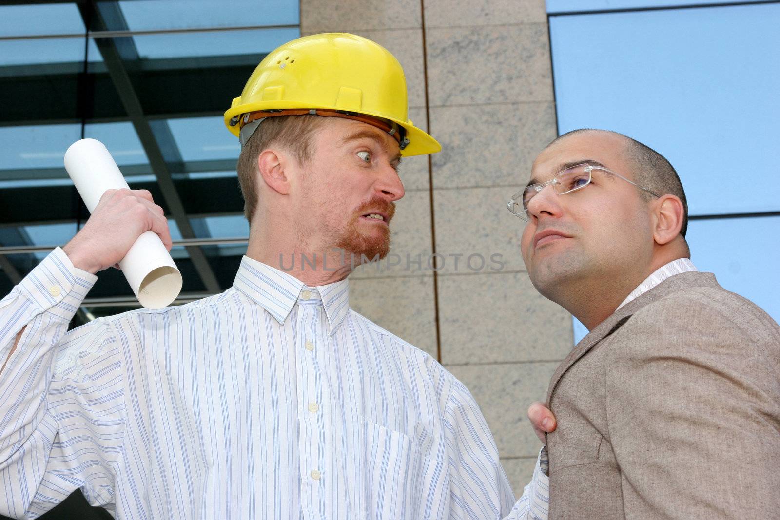 angry architect and businessman with architectural plans