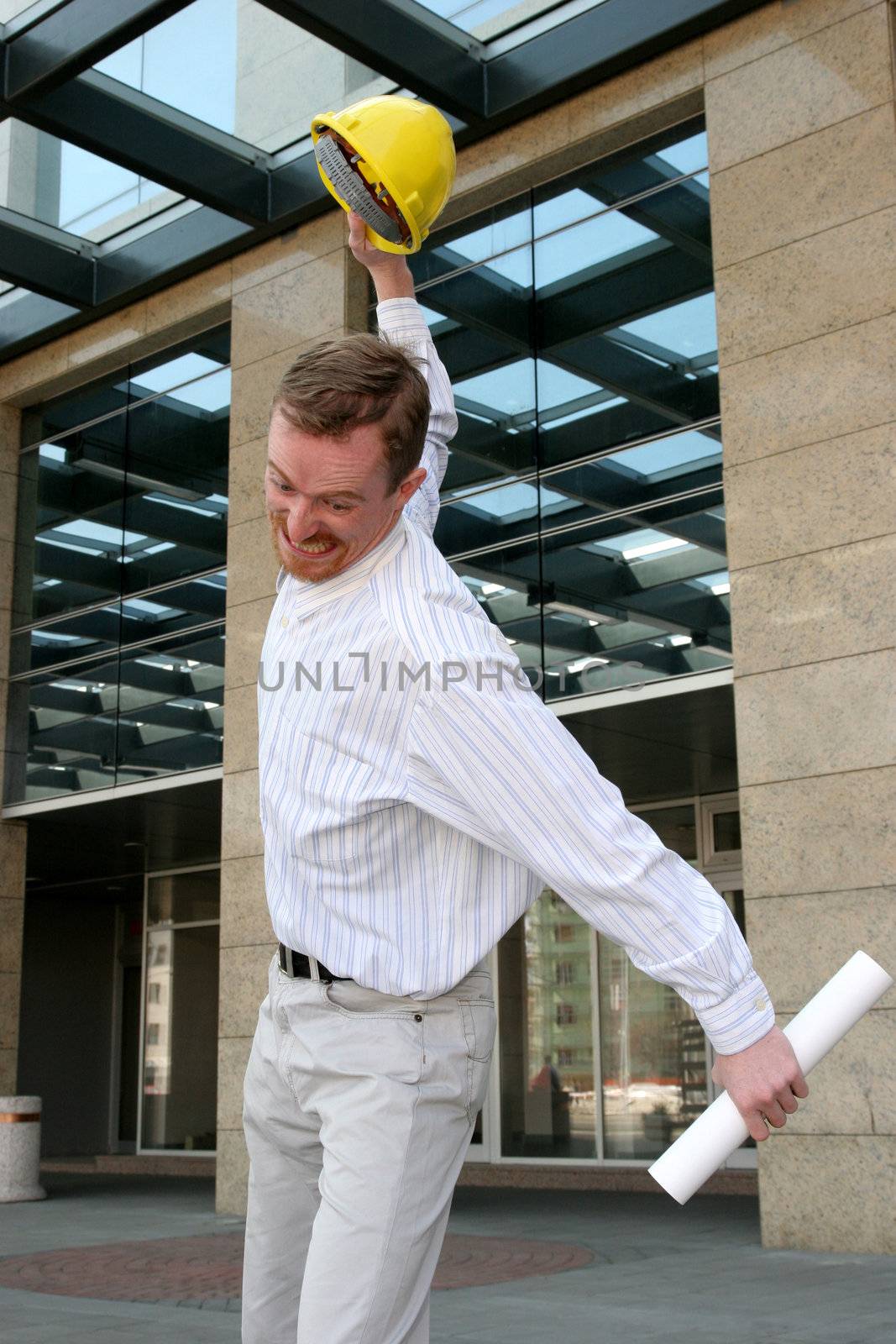 angry architect with helmet and architectural plans