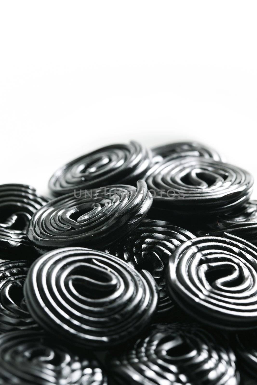 Rolls of tasty liquorice candy rolls isolated on white