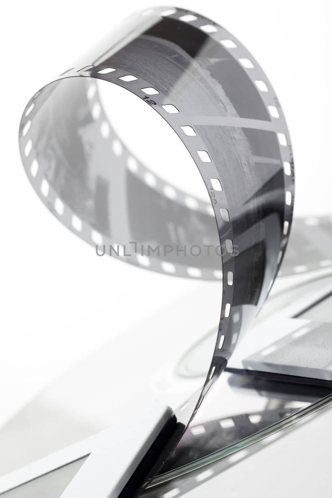 black and white negative film strip, dia and cd on white background