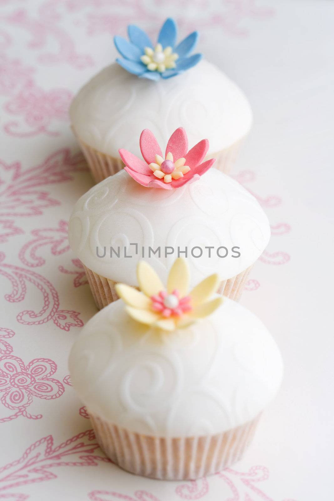 Cupcakes decorated with embossed fondant and sugar flowers