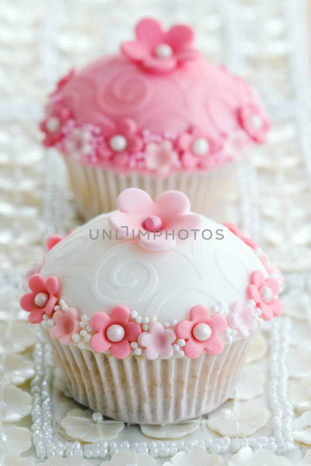 Wedding cupcakes decorated with a pink and white theme