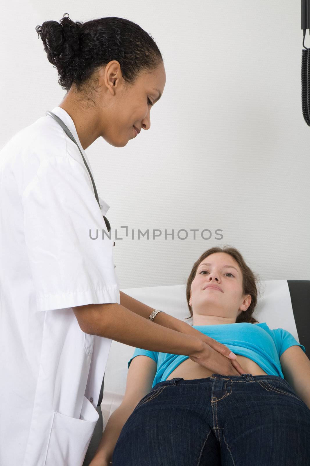 Doctor checking the stomach of one of her patients