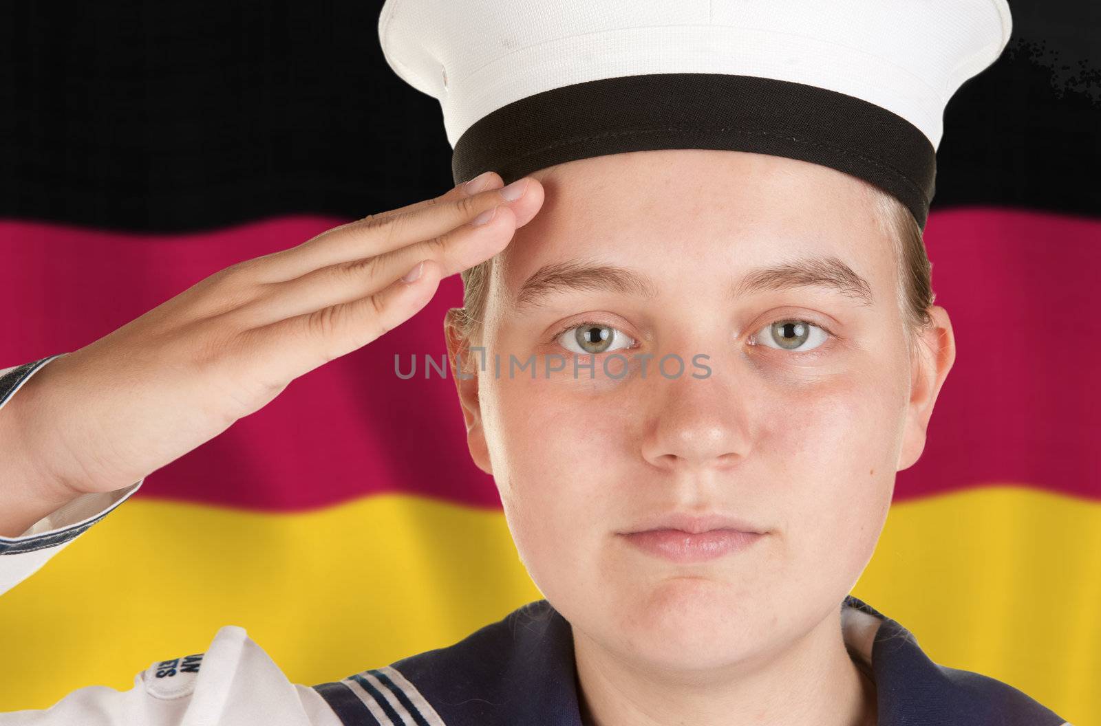 young female sailor saluting in front of german flag 