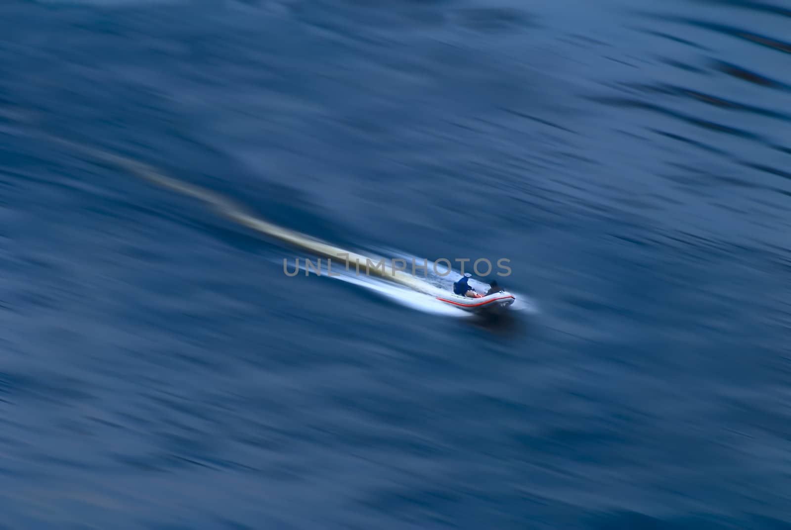 The boat rushing on a surface of the sea.