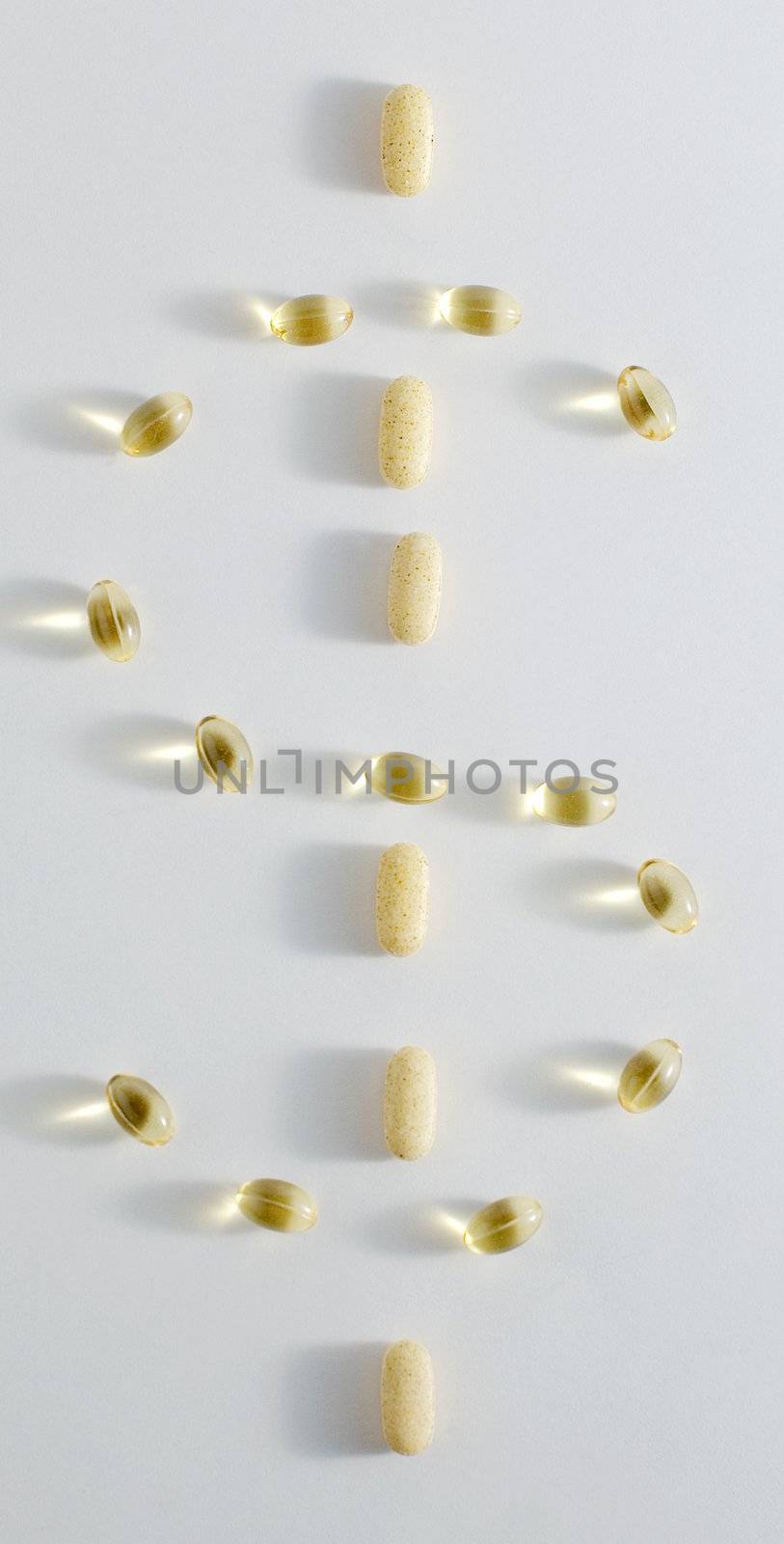 Pills in the shape of a dollar sign, against white background.