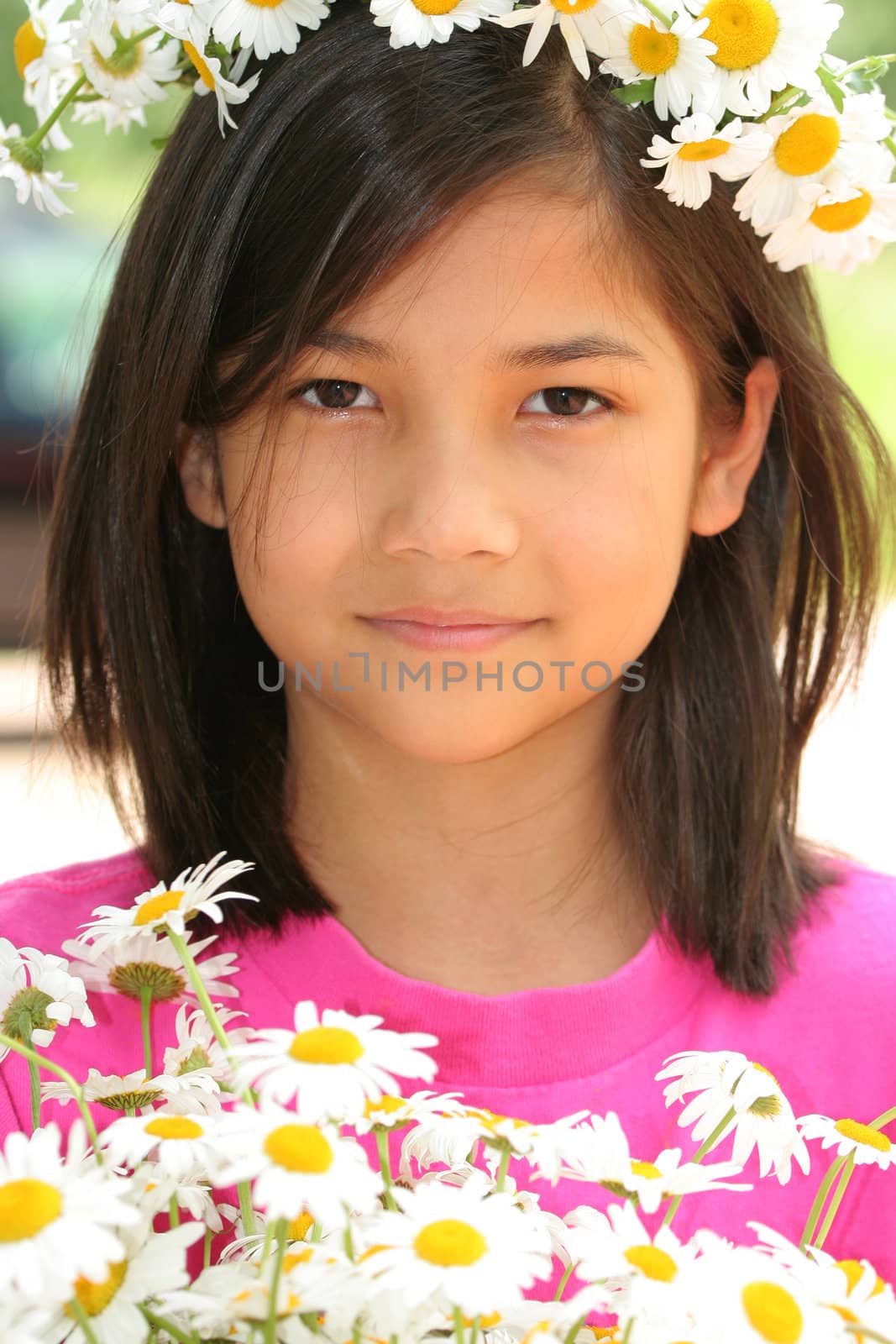 Little girl with crown of daisies