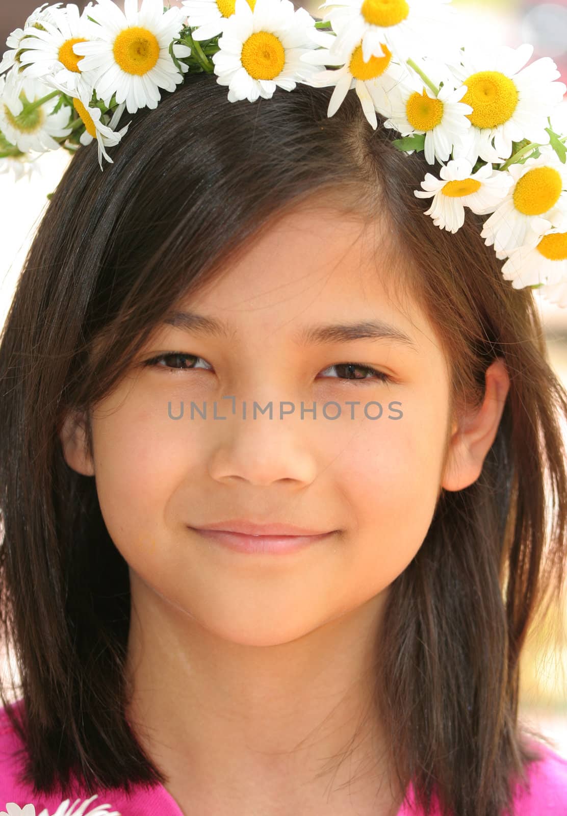 Little girl with crown of daisies