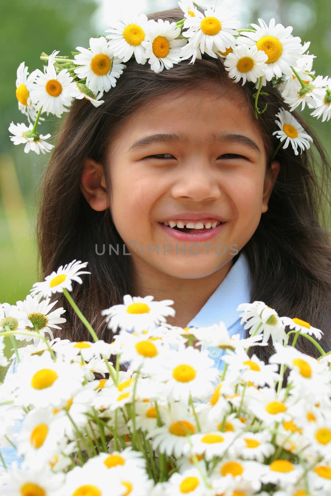 Beautiful little girl with crown of daisies