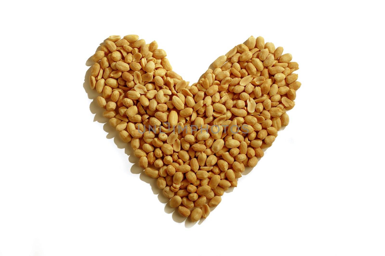 Peanuts forming heart symbol on white background.