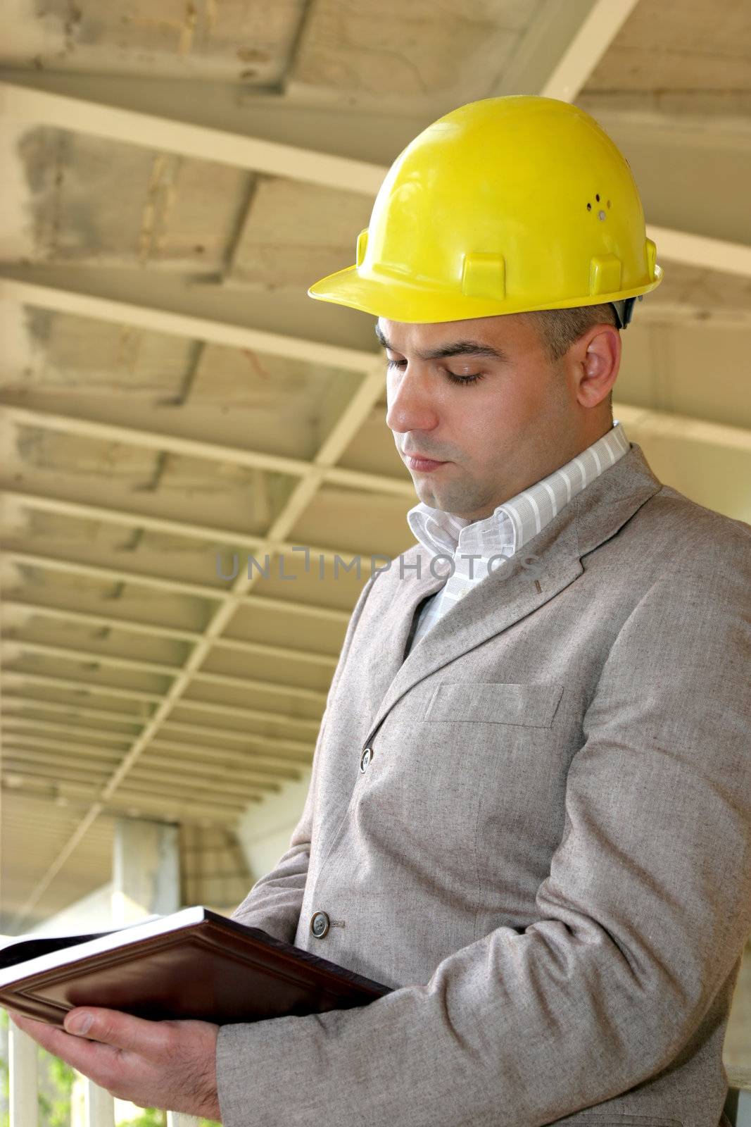 Businessman with time schedule under the bridge