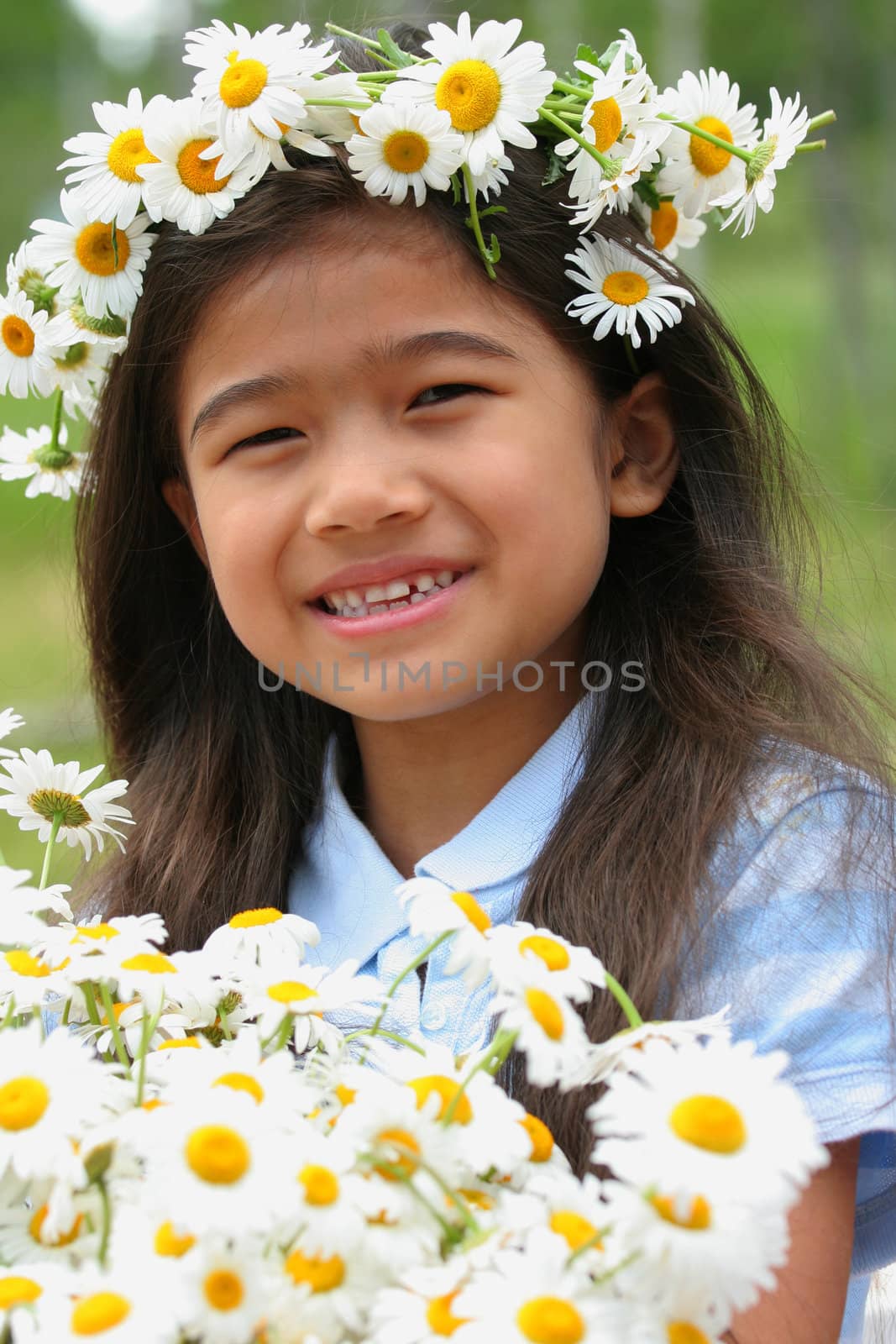 Beautiful little girl with crown of daisies