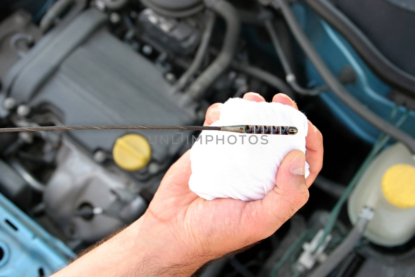 Details checking engine oil dipstick in car