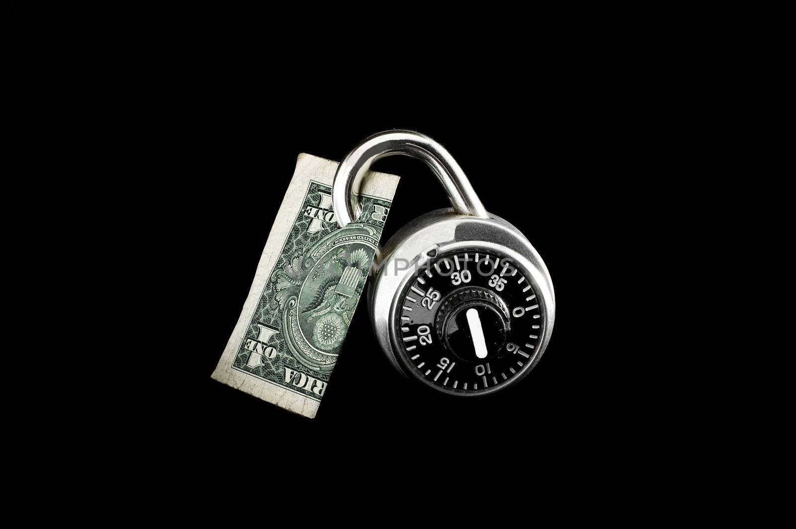Dollar bill locked by combination lock on black background.