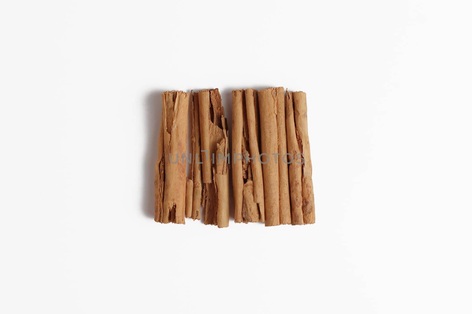 Cinnamon sticks dispaly isolated on white background.