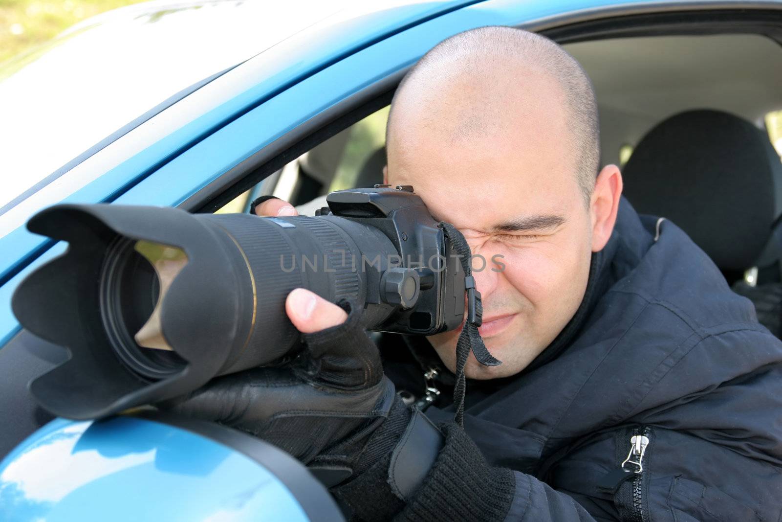 Professional photographer in action with telephoto lens, paparazzi