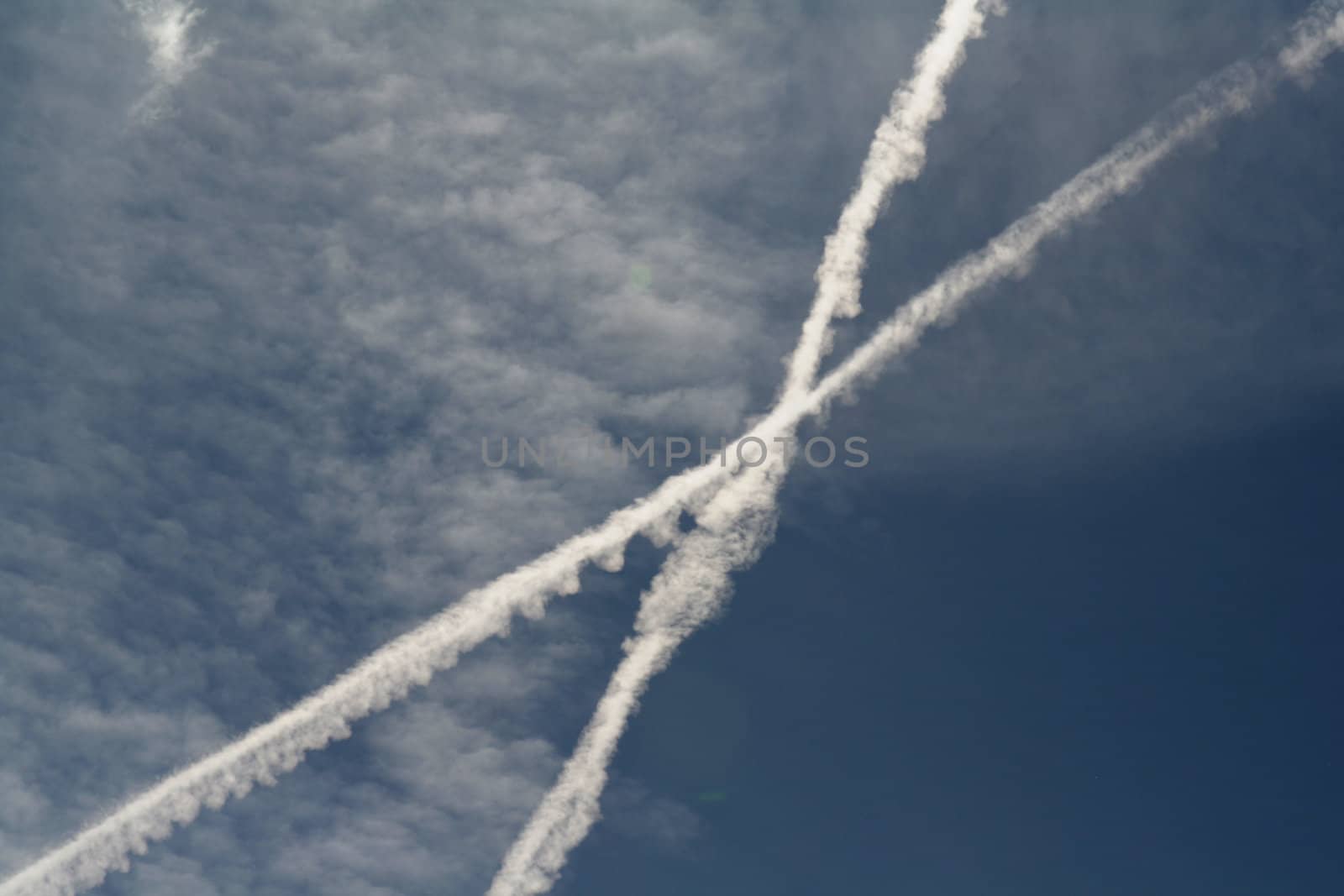 Two jet streams crossing in the sky.