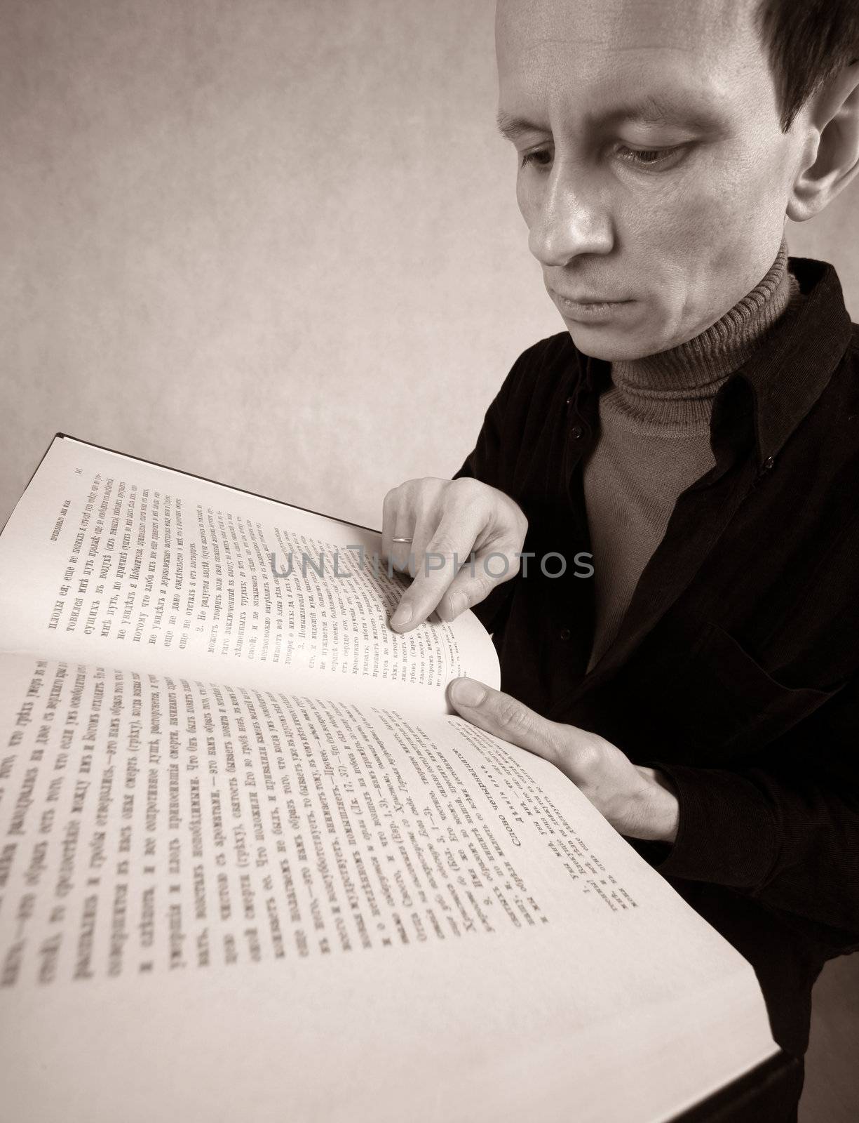 The adult man with the open book