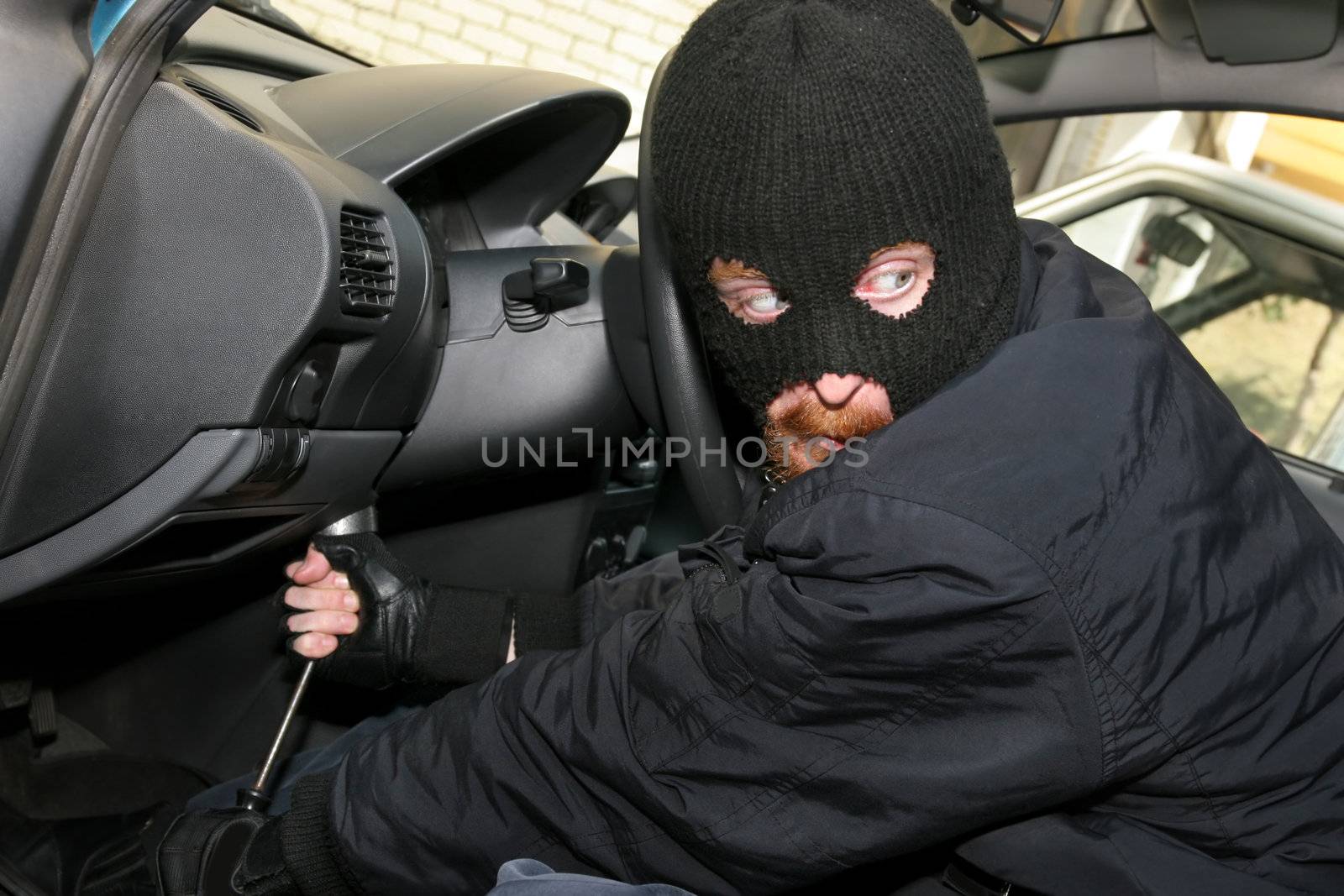 burglar wearing a mask (balaclava), details car burglary inside