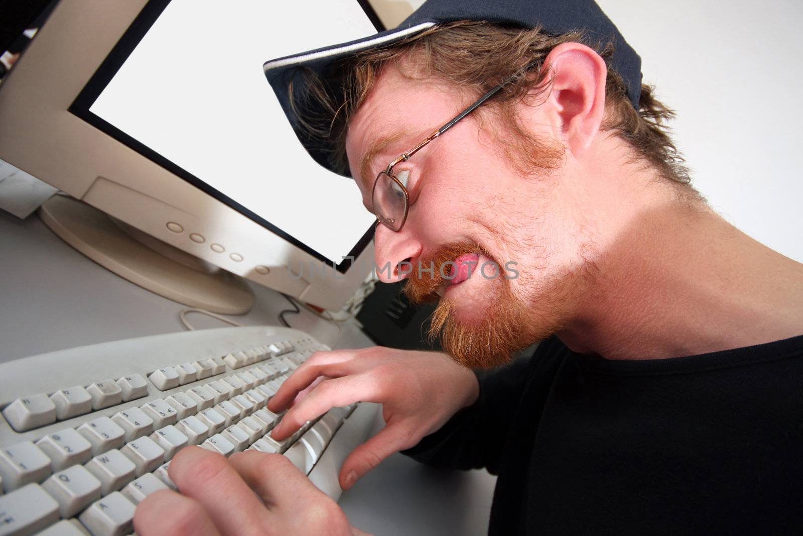 mad programmer sitting at a computer desk