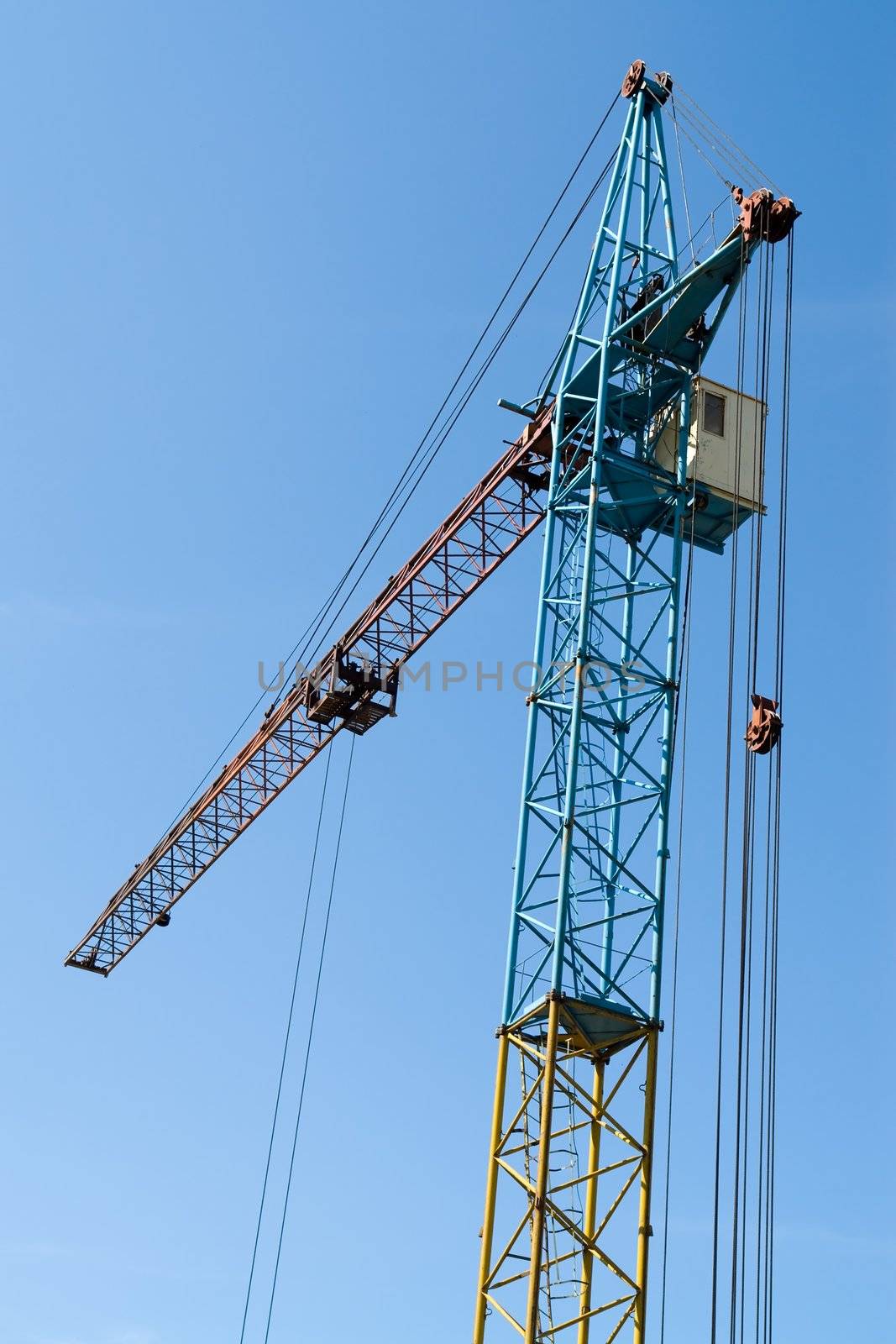 building tower crane against the blue sky