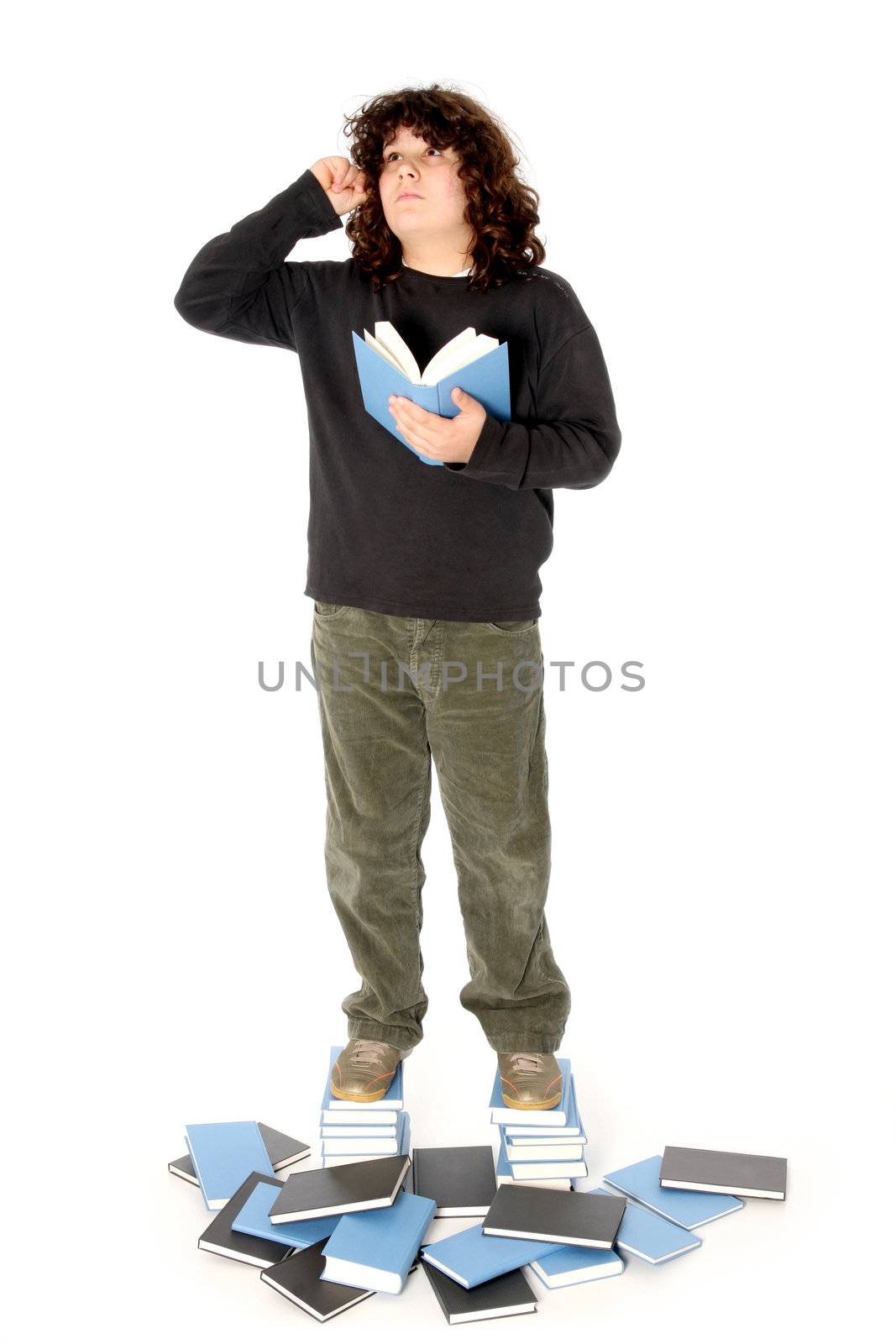 boy on stack of books on white background