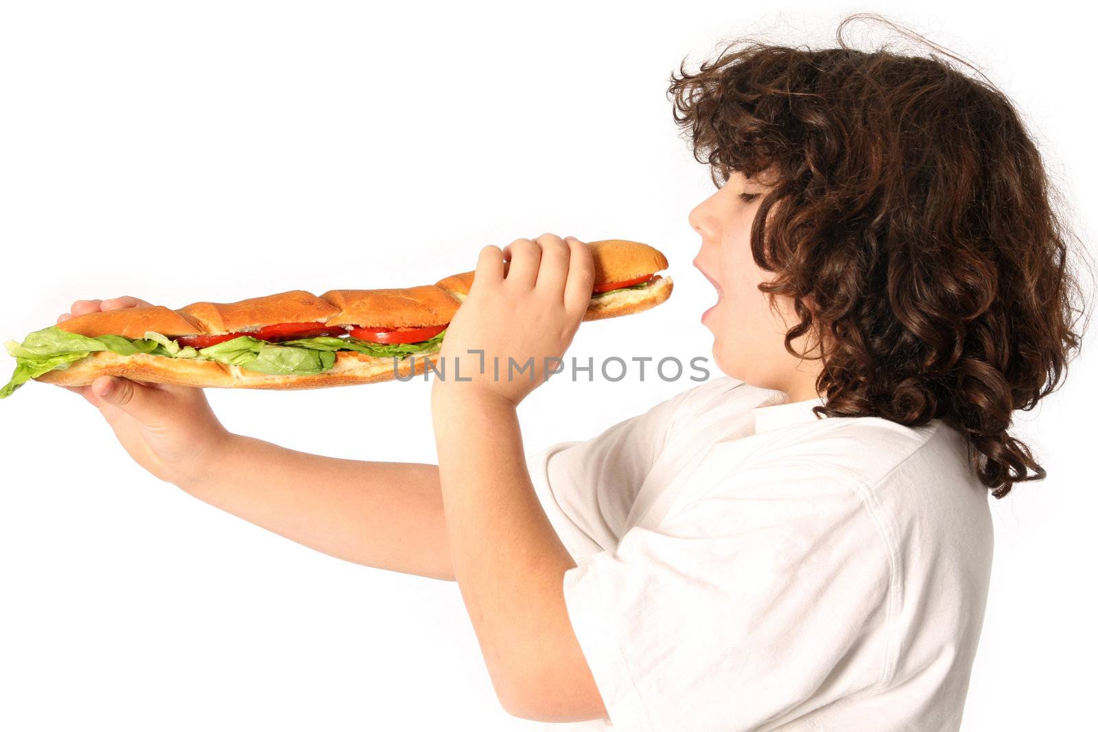 boy eating large sandwich on white background