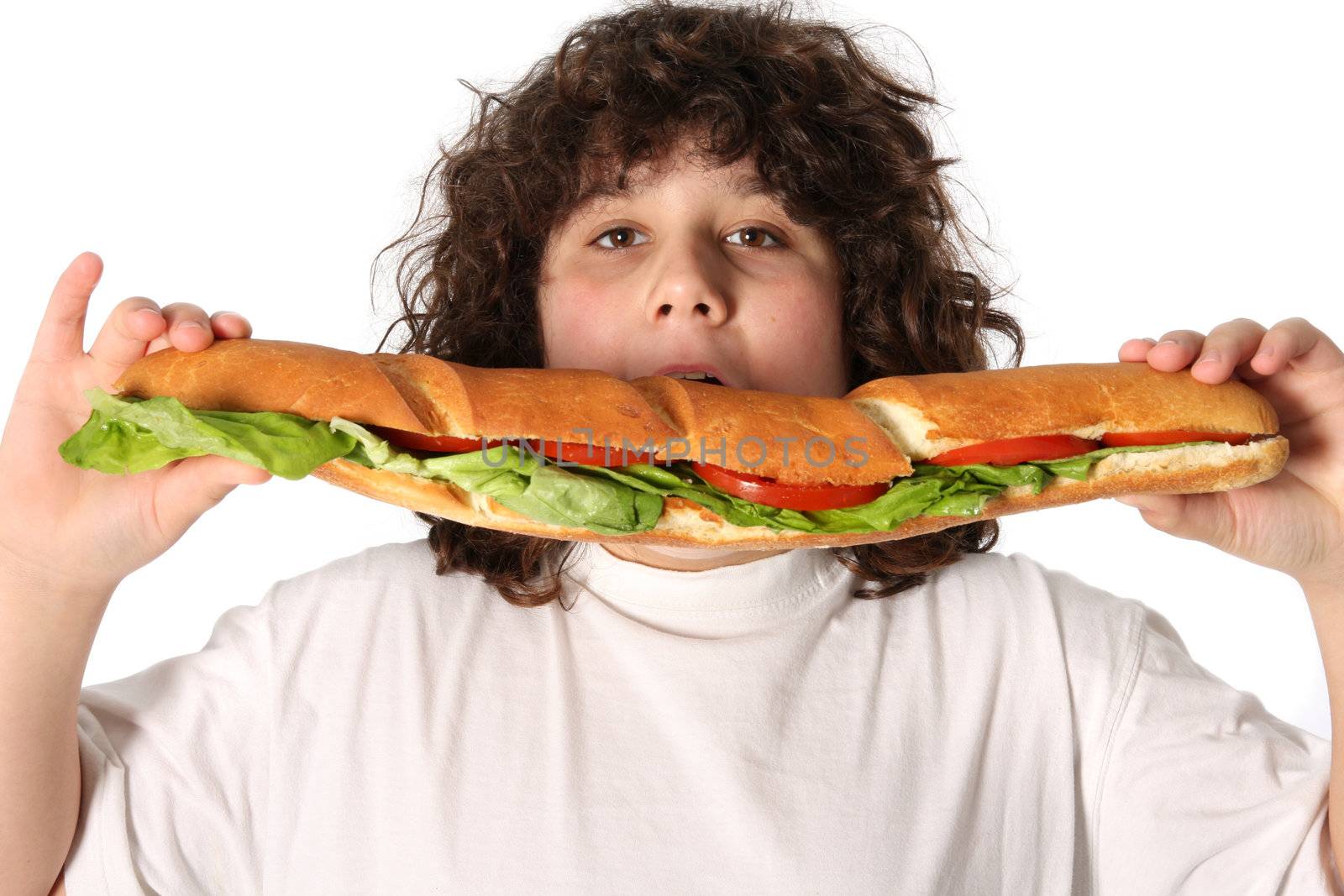 boy eating large sandwich on white background