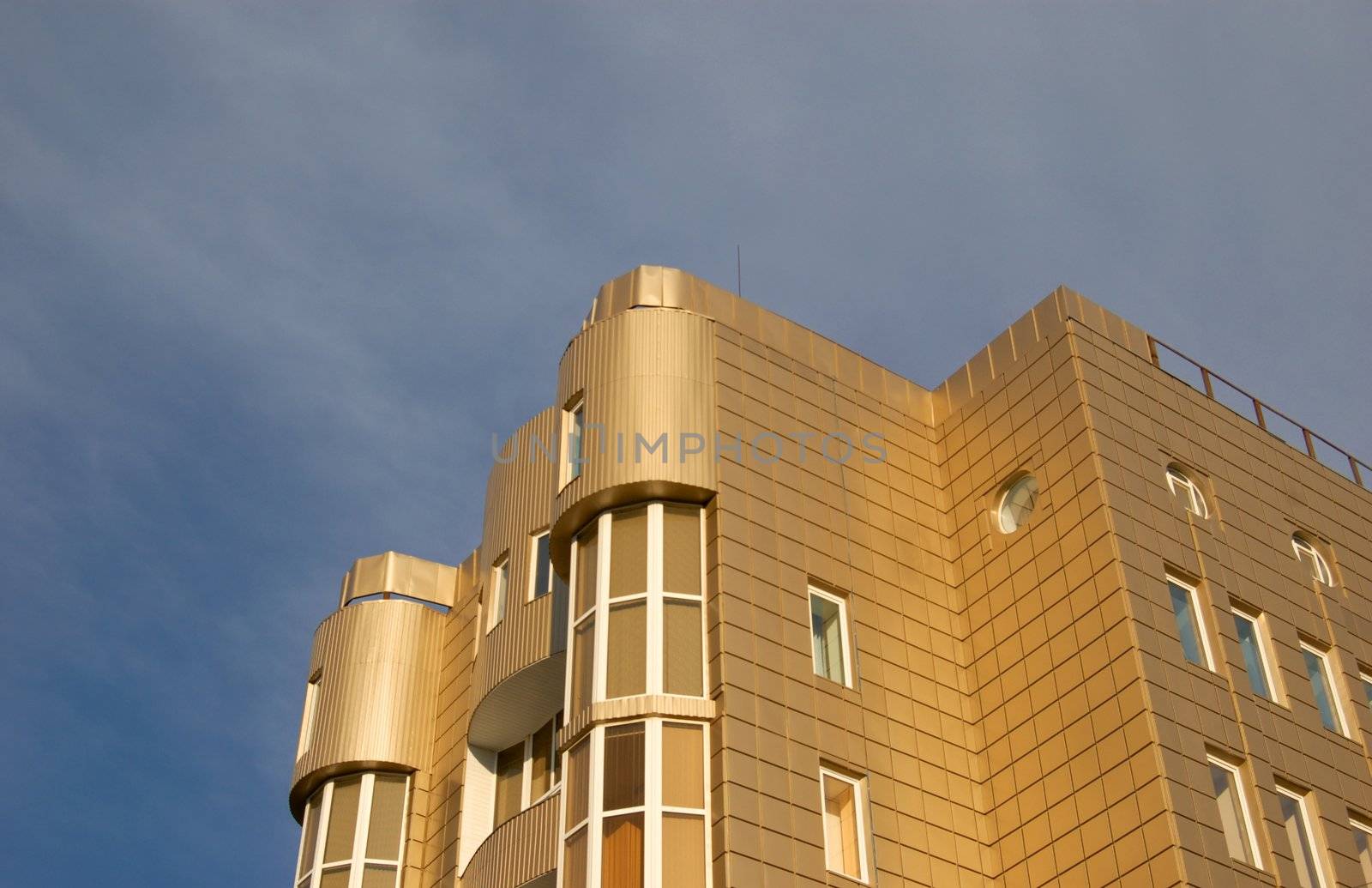 modern office building over blue sky with clouds