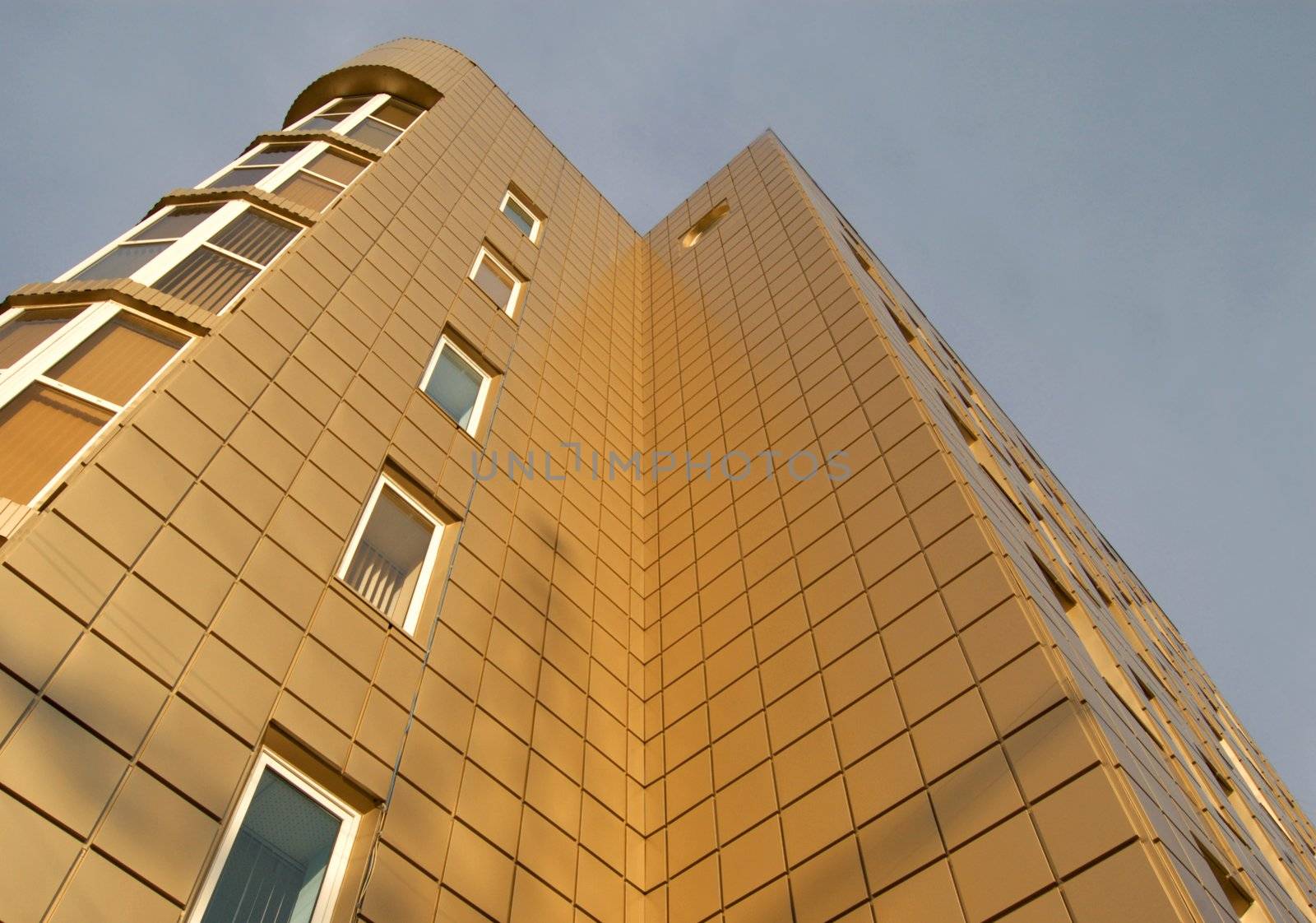 modern office building over blue sky with clouds